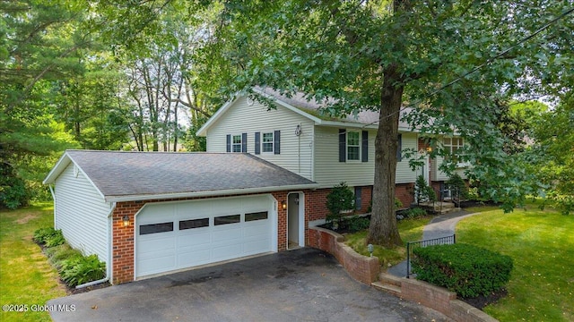 12 Lori Ln, Clifton Park, NY 12065 - view of front of home featuring brick siding, a shingled roof, driveway, a garage, and a front yard