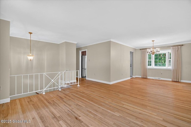 12 Lori Ln, Clifton Park, NY 12065 - empty room with a chandelier, light wood finished floors, and ornamental molding