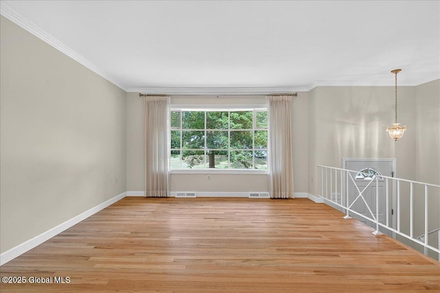12 Lori Ln, Clifton Park, NY 12065 - spare room with crown molding, light wood finished floors, and a chandelier