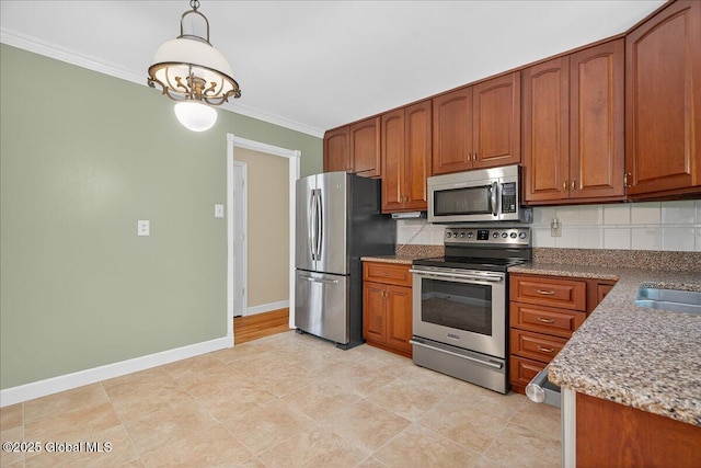 12 Lori Ln, Clifton Park, NY 12065 - kitchen with appliances with stainless steel finishes, ornamental molding, brown cabinetry, backsplash, and pendant lighting