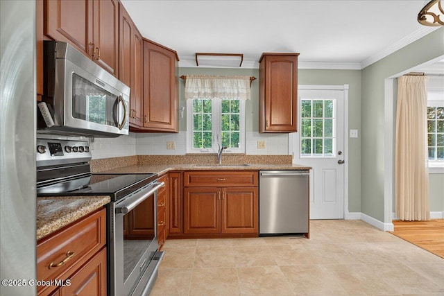 12 Lori Ln, Clifton Park, NY 12065 - kitchen with stainless steel appliances, ornamental molding, tasteful backsplash, light stone countertops, and brown cabinets