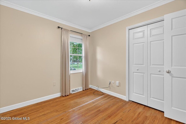 12 Lori Ln, Clifton Park, NY 12065 - unfurnished bedroom featuring ornamental molding, light wood-style flooring, and a closet