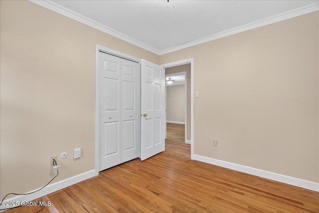 12 Lori Ln, Clifton Park, NY 12065 - unfurnished bedroom with ornamental molding, light wood-style flooring, and a closet