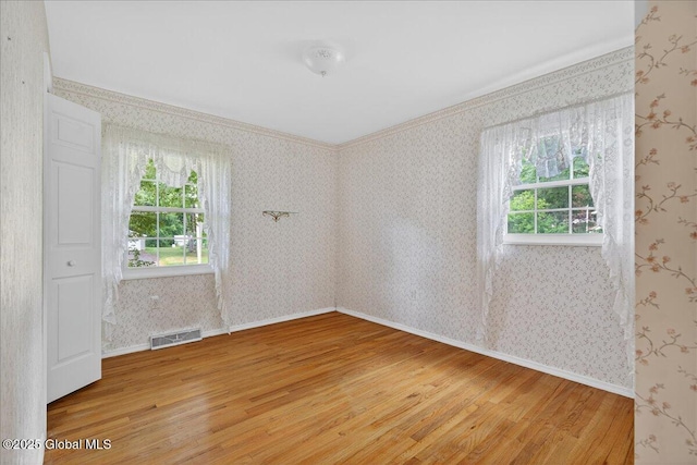 12 Lori Ln, Clifton Park, NY 12065 - unfurnished room with light wood-style floors, healthy amount of natural light, crown molding, and wallpapered walls
