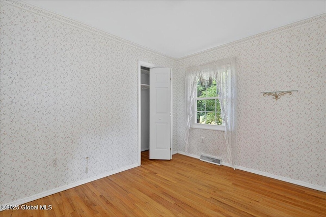 12 Lori Ln, Clifton Park, NY 12065 - unfurnished bedroom featuring wood finished floors, wallpapered walls, and ornamental molding