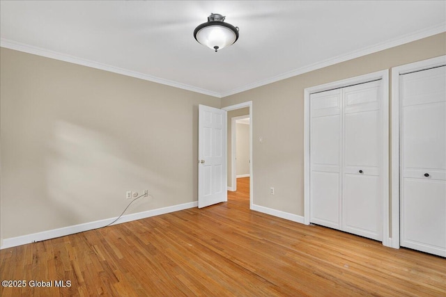 12 Lori Ln, Clifton Park, NY 12065 - unfurnished bedroom with light wood-style flooring, two closets, and ornamental molding