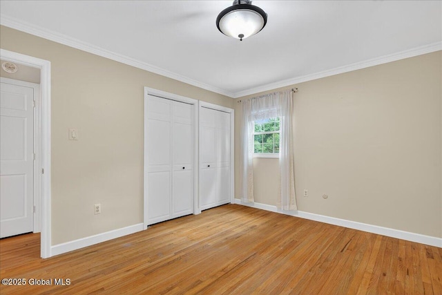 12 Lori Ln, Clifton Park, NY 12065 - unfurnished bedroom featuring light wood-style flooring, two closets, and crown molding
