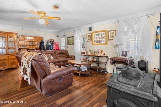 living room with ceiling fan, ornamental molding, and dark wood-type flooring