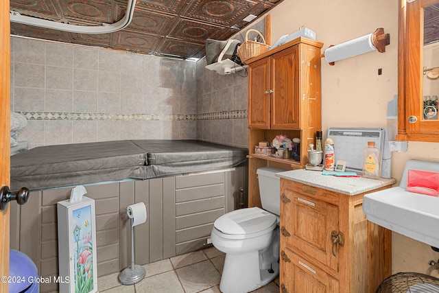 bathroom featuring tile patterned flooring, toilet, and sink