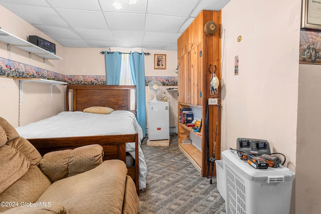 carpeted bedroom with a drop ceiling