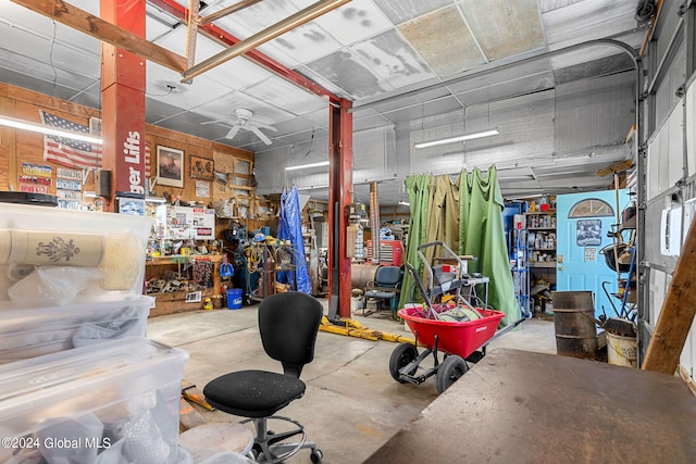 garage with a workshop area and ceiling fan