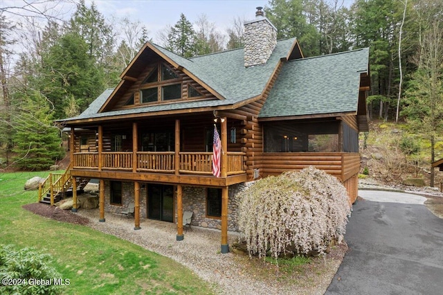 log home with a wooden deck