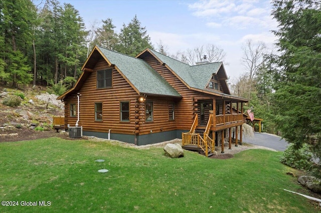 exterior space with a lawn and central AC