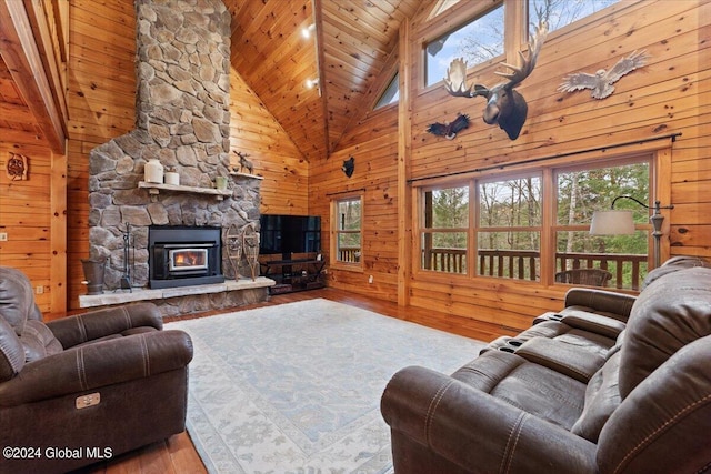 living room featuring wooden walls, light wood-type flooring, wood ceiling, and high vaulted ceiling