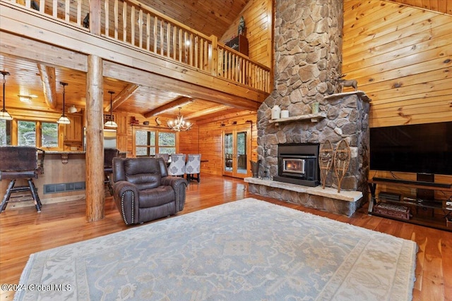 living room with hardwood / wood-style floors, a wealth of natural light, and wood ceiling