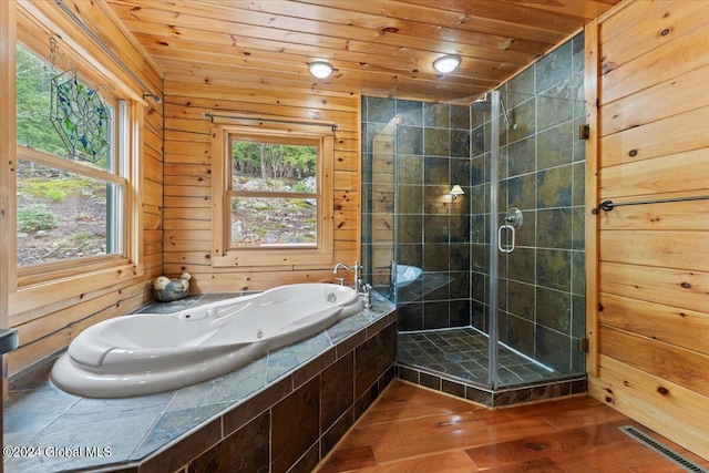 bathroom with hardwood / wood-style flooring, independent shower and bath, wooden ceiling, and wooden walls