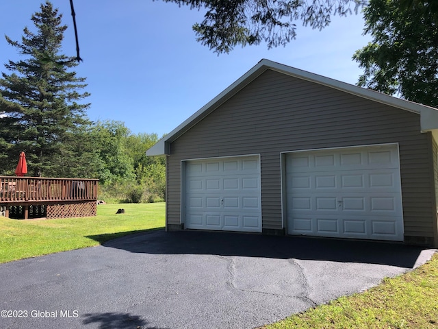 garage featuring a lawn