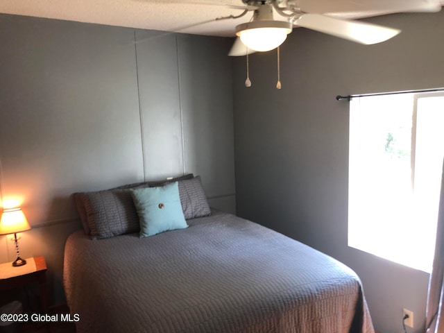 bedroom featuring ceiling fan and multiple windows