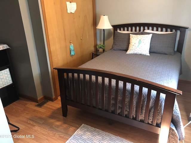 bedroom with hardwood / wood-style flooring