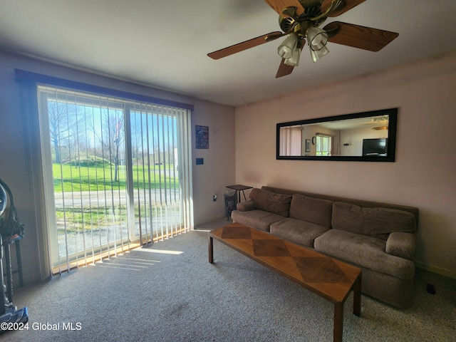 living room with ceiling fan and carpet flooring