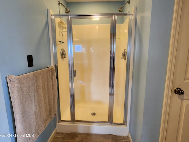 bathroom featuring walk in shower and tile floors