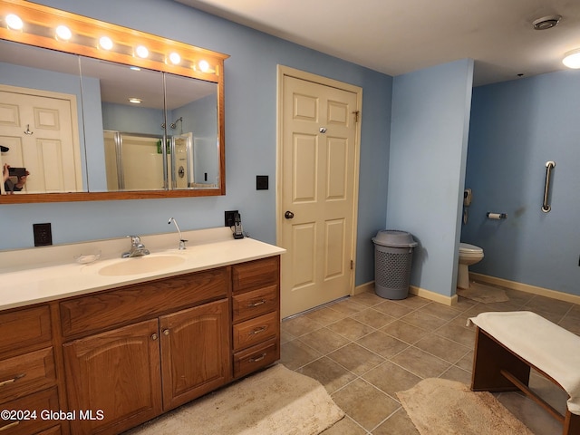 bathroom with vanity, tile floors, and toilet