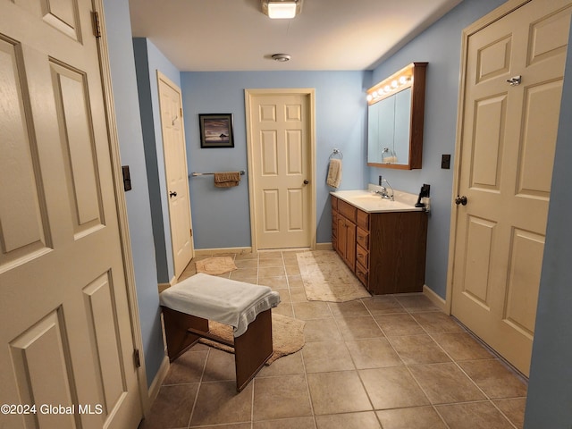 bathroom with tile flooring and vanity