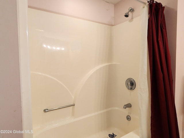 bathroom with shower / bath combination with curtain