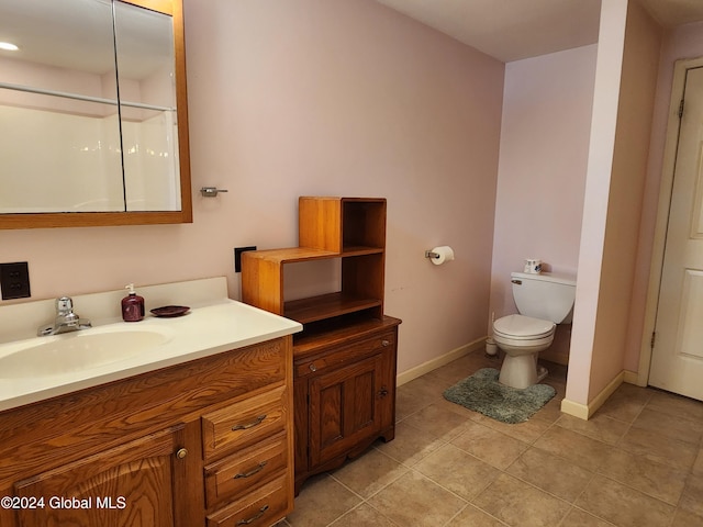 bathroom with oversized vanity, toilet, and tile flooring