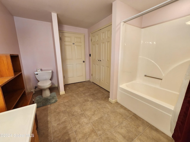 full bathroom with tile flooring, washtub / shower combination, vanity, and toilet