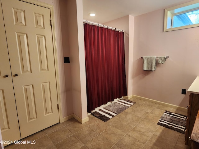 bathroom featuring tile flooring and vanity