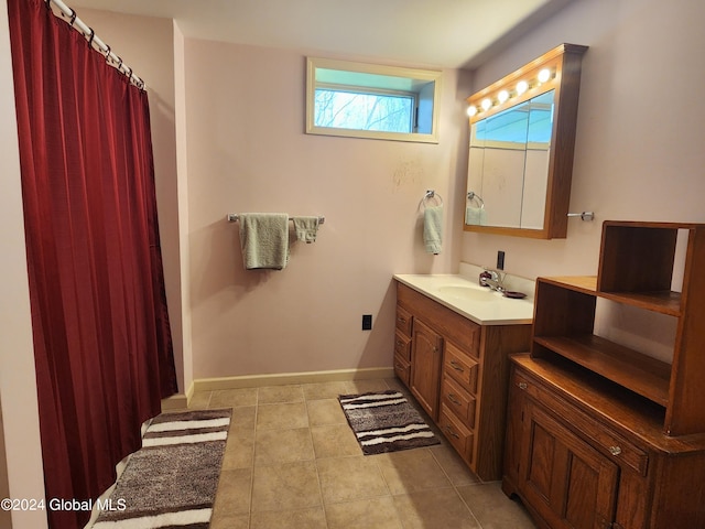 bathroom with tile flooring and vanity