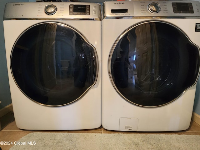 laundry room with light tile flooring and washer and dryer