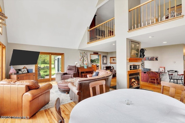 dining room featuring wood-type flooring and high vaulted ceiling