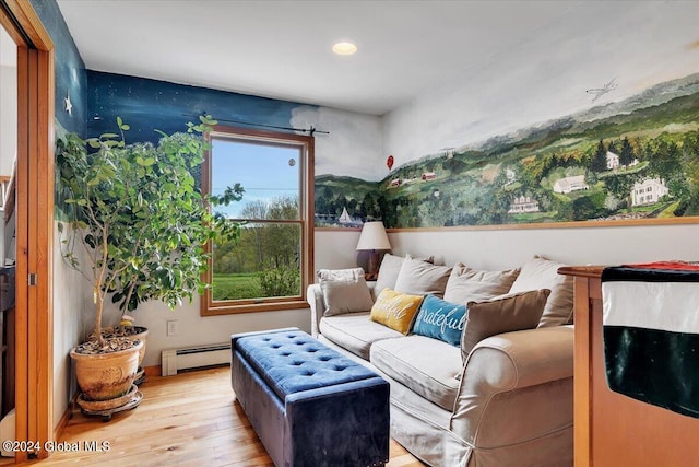 living room with light hardwood / wood-style flooring and a baseboard heating unit