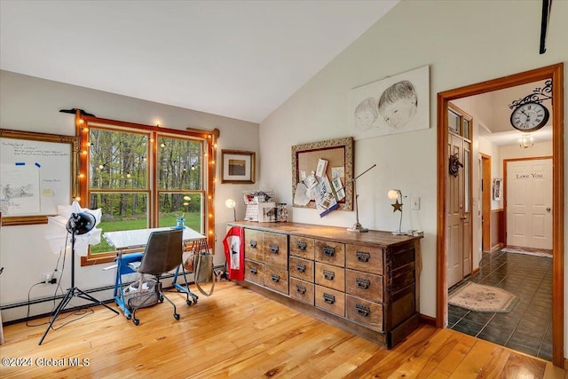 office space with hardwood / wood-style flooring and high vaulted ceiling