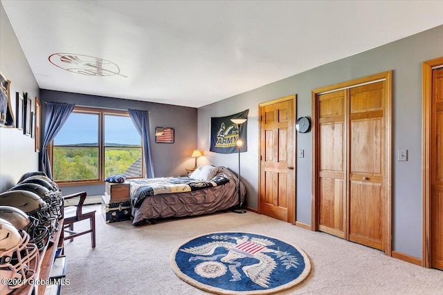 carpeted bedroom featuring a baseboard radiator