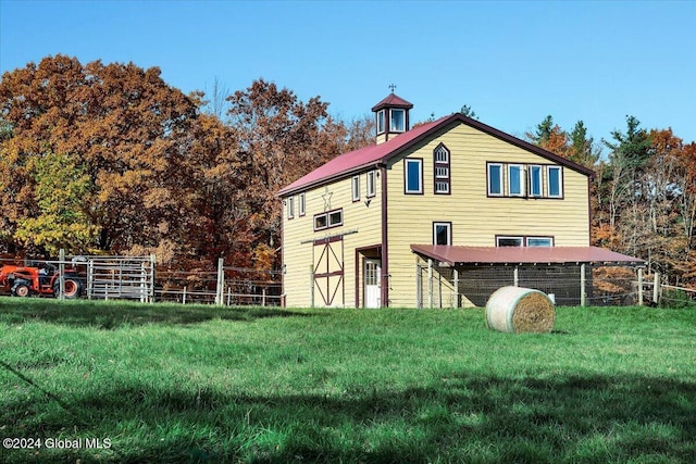 rear view of property with a lawn