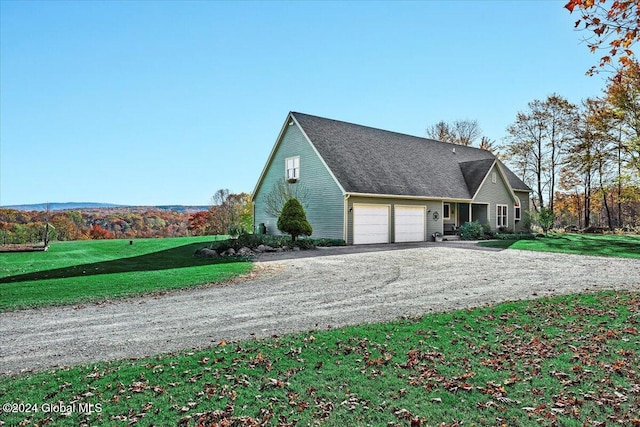 view of side of home featuring a yard and a garage