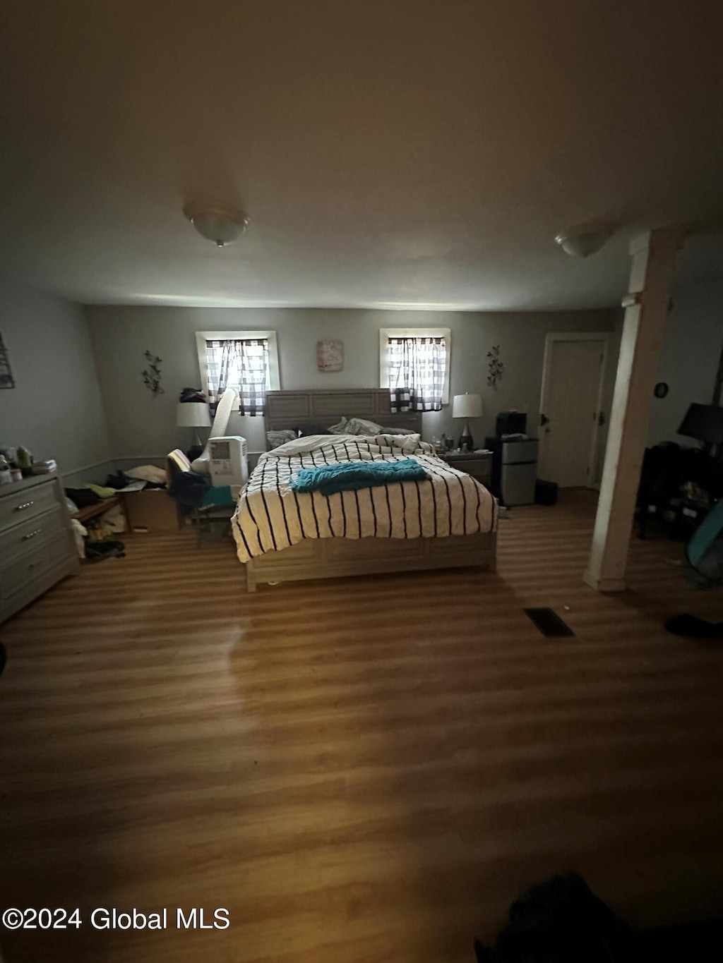 bedroom featuring hardwood / wood-style flooring and multiple windows