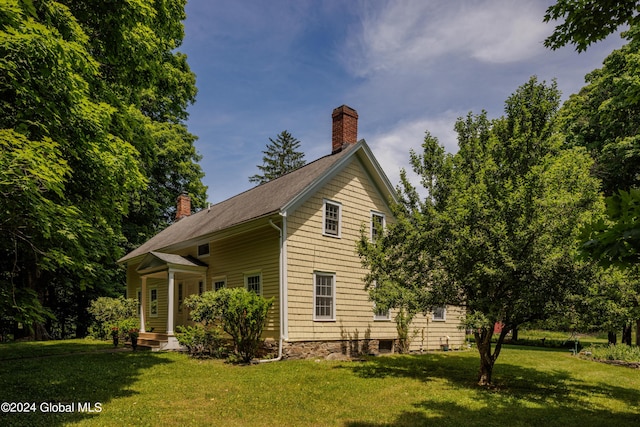 view of property exterior featuring a yard