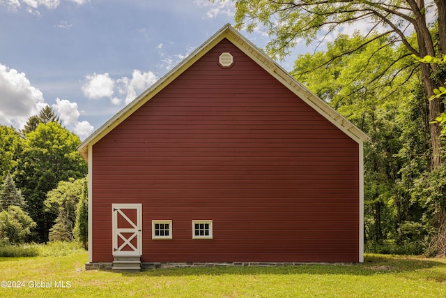 view of side of home with a lawn