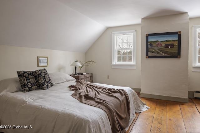 bedroom featuring vaulted ceiling and hardwood / wood-style flooring