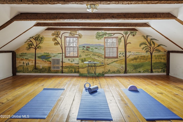 exercise area with lofted ceiling and hardwood / wood-style floors