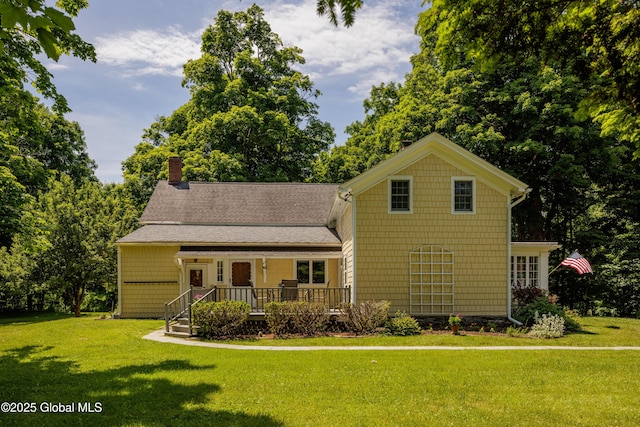 view of front of property featuring a front lawn and a deck