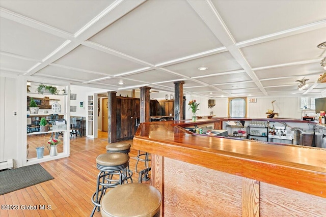 interior space with hardwood / wood-style flooring and coffered ceiling