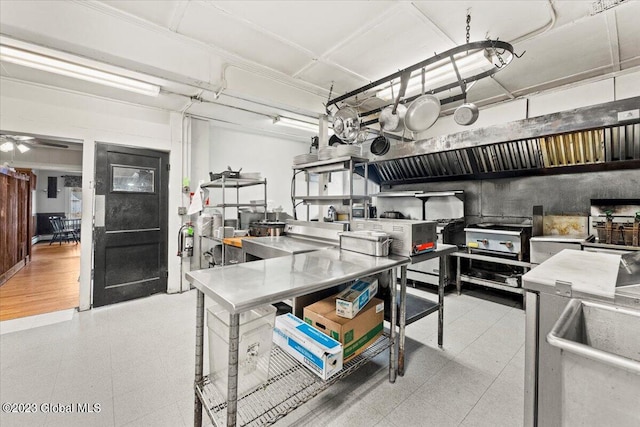 kitchen with stainless steel counters and light tile floors