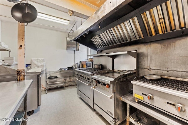 kitchen with high end range, premium range, and light tile floors