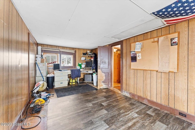 home office featuring wood walls and dark wood-type flooring