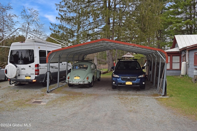 view of vehicle parking with a carport